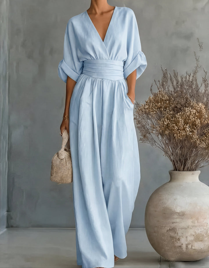 Detail of the elegant wrap-style bodice on a women's wide-leg jumpsuit.