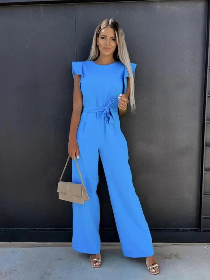 Comfortable wide leg jumpsuit for women, featuring a stylish tie waist & ruffle sleeves for versatile wear.