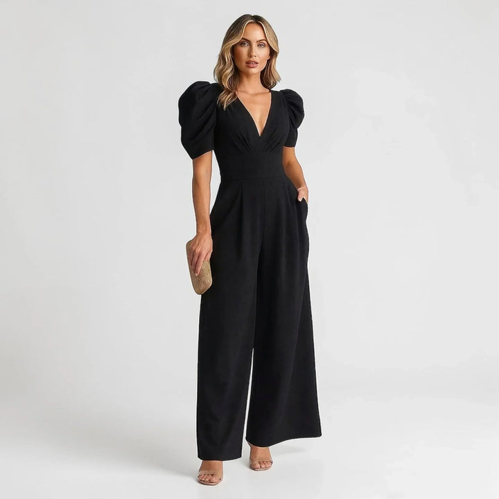Black women's tailored wide-leg jumpsuit featuring chic puff sleeves, great for evening events.