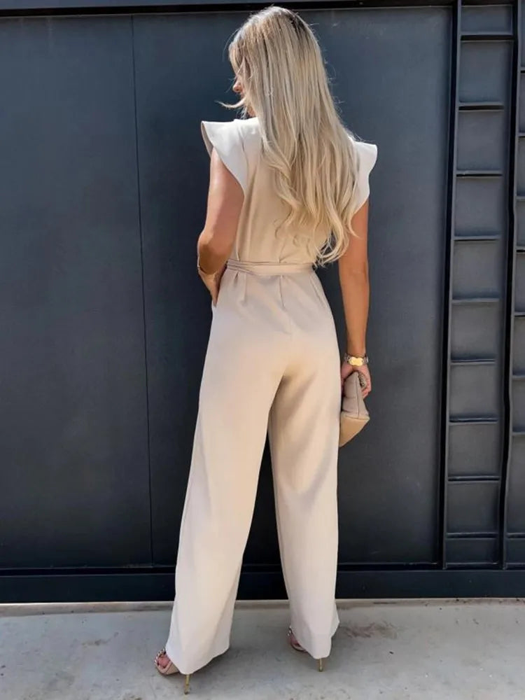 Chic V-neck wide leg jumpsuit for women, featuring stylish ruffled sleeves and an adjustable tie waist. Resort wear.