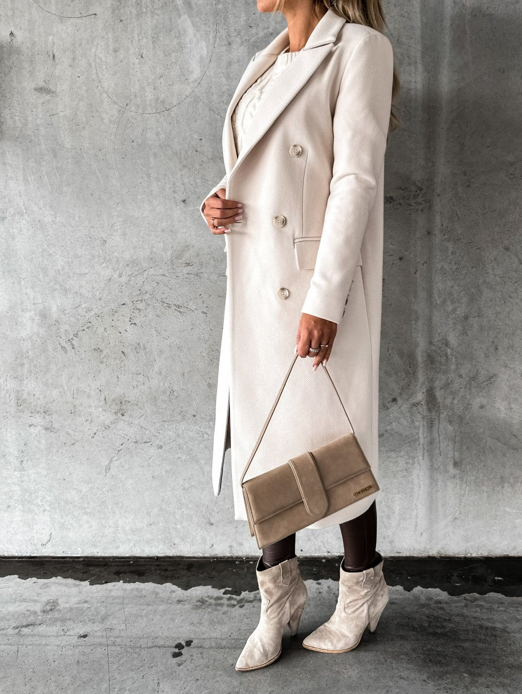 Fashionable khaki women's winter coat. Warm, elegant long-sleeve outerwear for stylish cold-weather protection.