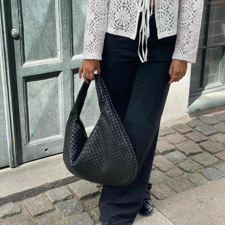 Luxurious soft vegan leather women's woven slouch shoulder bag. An elegant everyday handbag and fashion accessory.