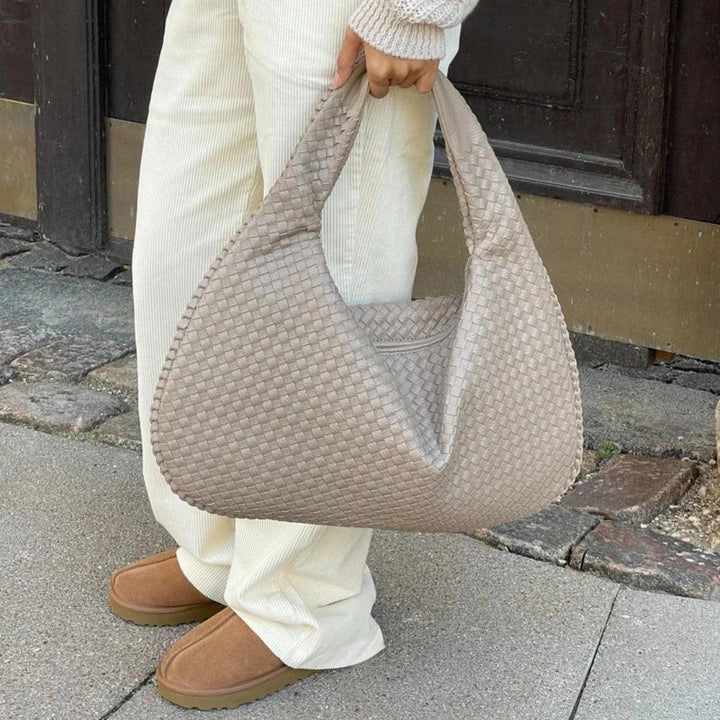 Stylish women's woven shoulder bag, crafted from soft vegan leather with a distinctive slouch design. Everyday elegance.