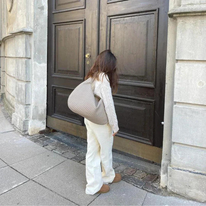 Women's elegant woven slouch shoulder bag, made with soft vegan leather. A versatile fashion accessory for any outfit.
