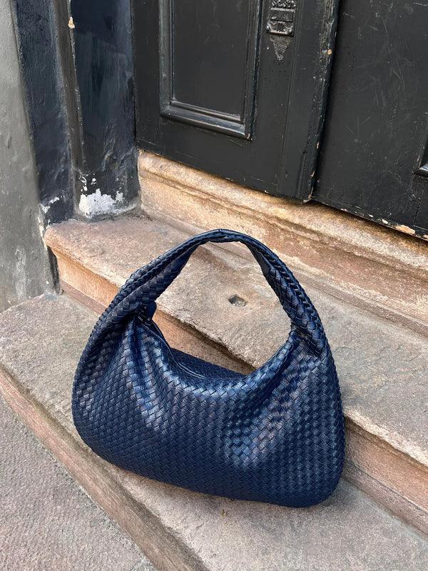 Modern women's woven vegan leather slouch shoulder bag. A stylish and practical everyday handbag to complete your look.
