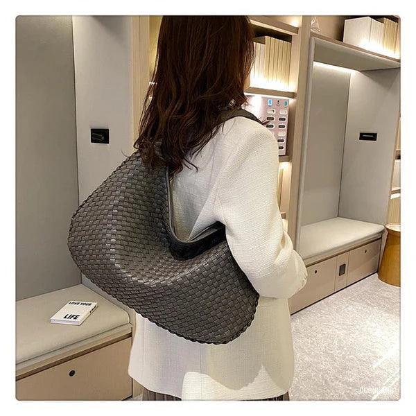 Soft vegan leather women's woven shoulder bag with a slouch design, ideal as an elegant everyday handbag accessory.