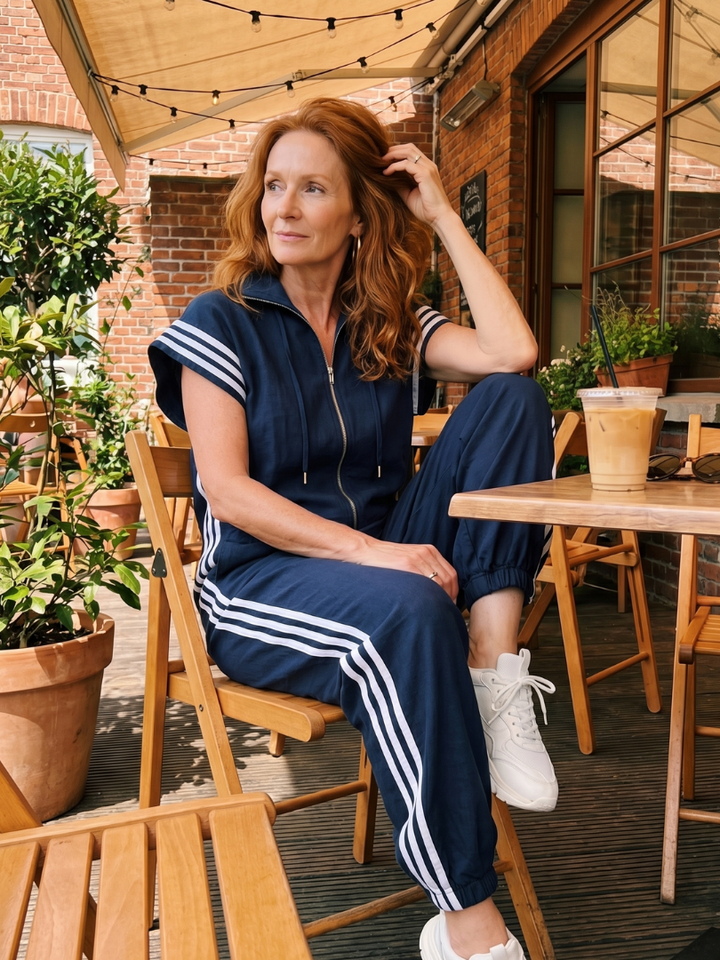 Versatile women's striped panel jumpsuit, zip front, wide leg, full length & elegant design.