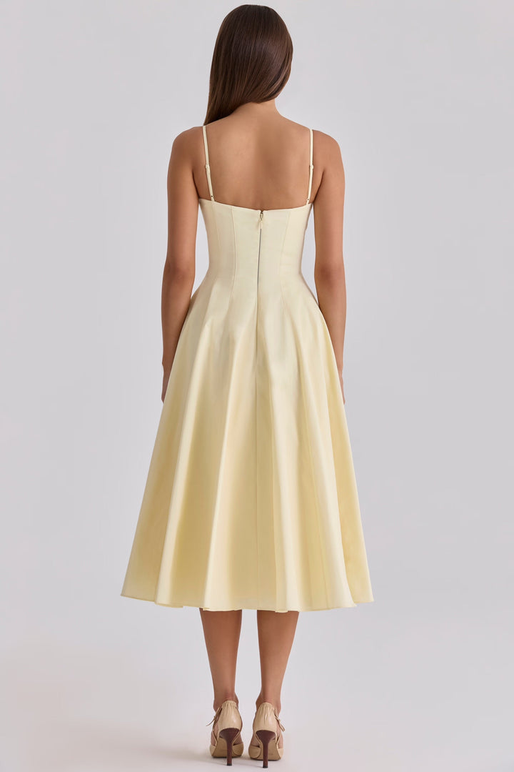 Flowy yellow midi dress for women, featuring a gathered bust. Perfect comfortable and casual summer vacation style.