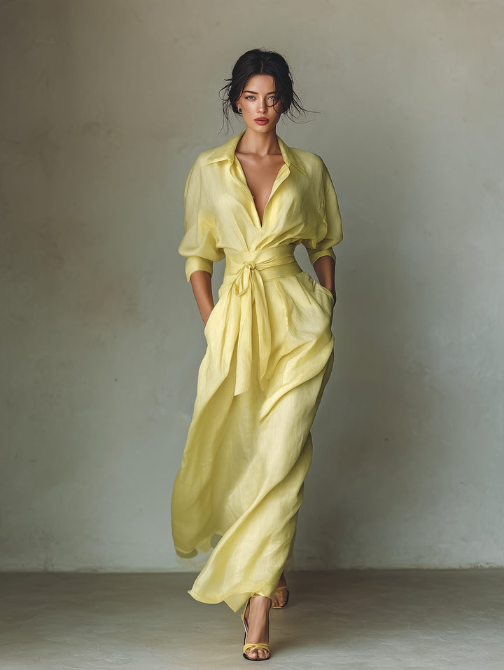 Flowy yellow women's maxi shirt dress with a stylish tie-waist & half sleeves. Elegant yet casual for summer days.