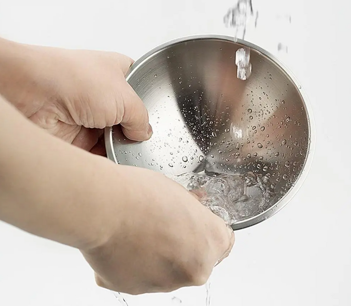 White elevated double cat bowl with two shiny stainless steel bowls for food and water.