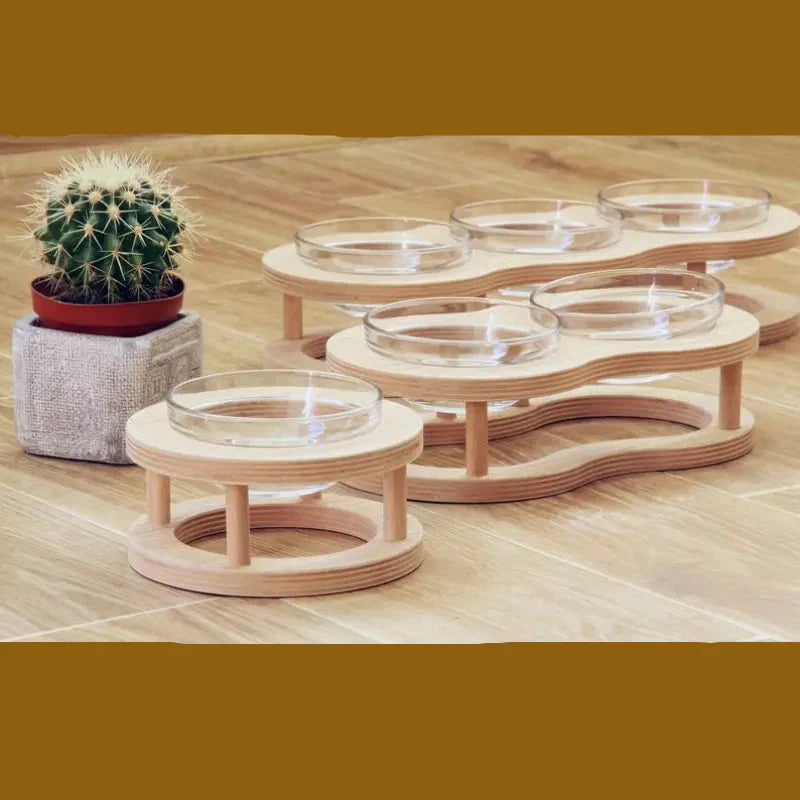Pet eating from an ergonomic elevated wood and glass feeding bowl set; non-slip base ensures stability.