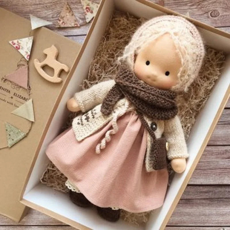 Elise handmade plush doll in a nursery setting.