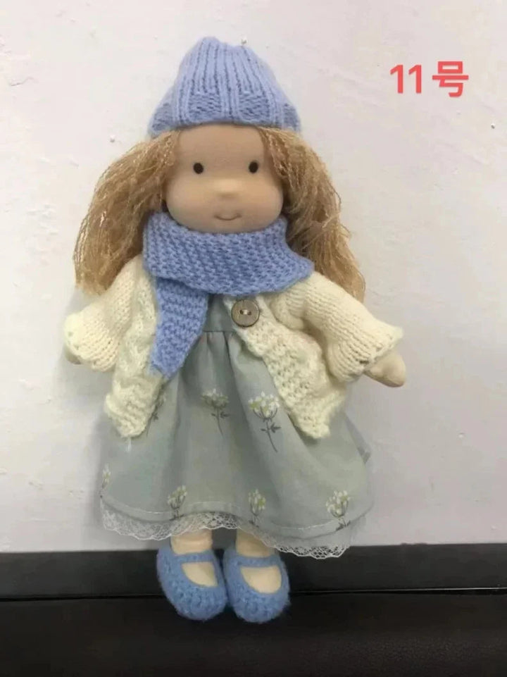 Full shot of Elise handmade doll wearing a simple cotton dress.