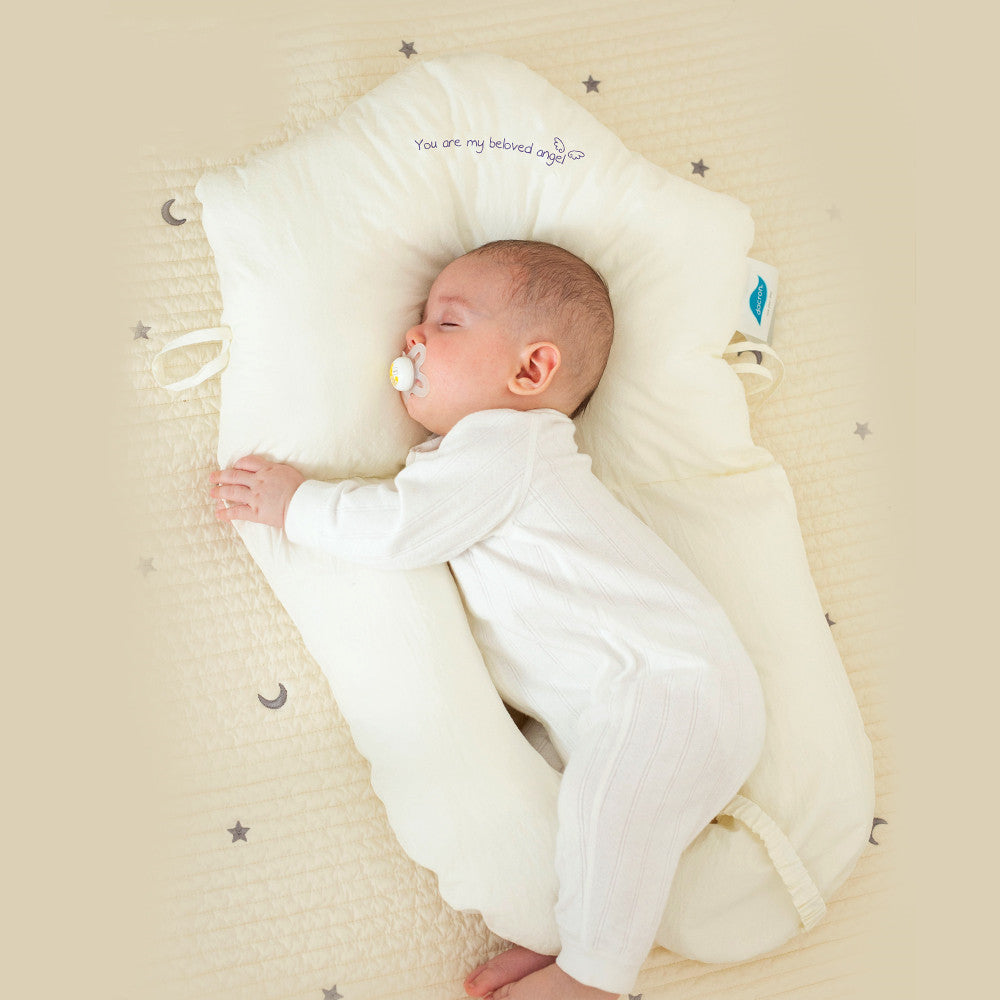 Ergonomic baby sleep cushion providing antibacterial cuddle support for safe newborn rest.