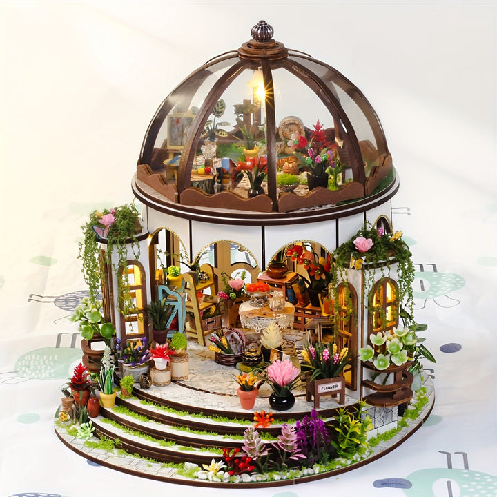 Finished miniature flower house 3D wooden puzzle with LED lighting, showcasing intricate garden details.