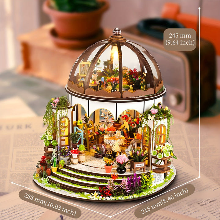 Detailed view of the miniature flower house garden, featuring tiny flowers, plants, and wooden elements.