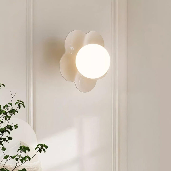 Floral resin wall lamp with delicate glass shade, modern indoor decor.