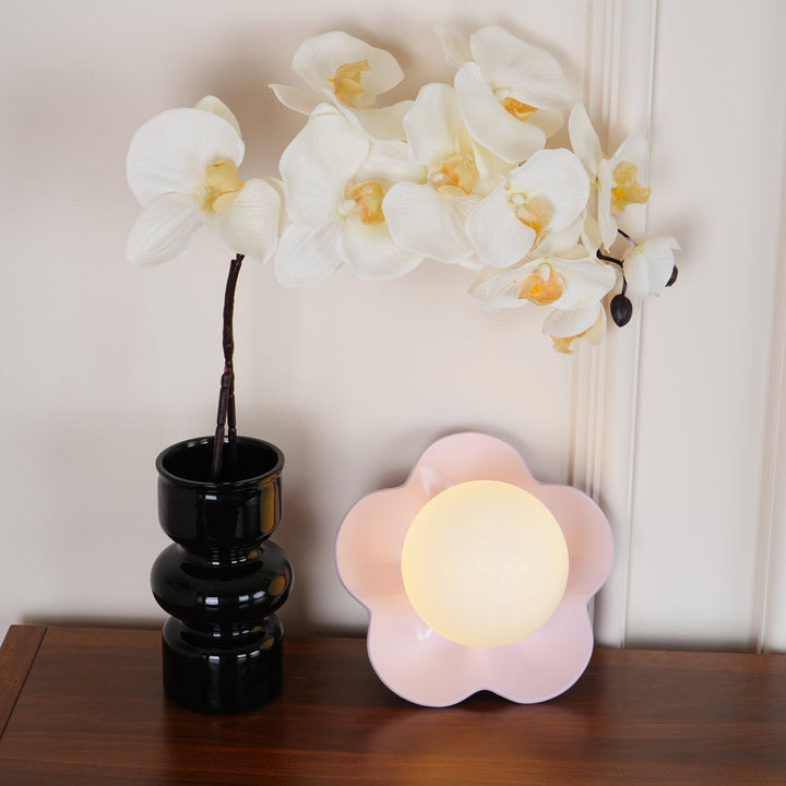 Decorative floral resin wall light for a stylish home accent.