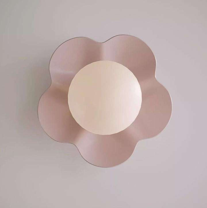 Sculpted floral resin wall lamp with a clear glass shade.