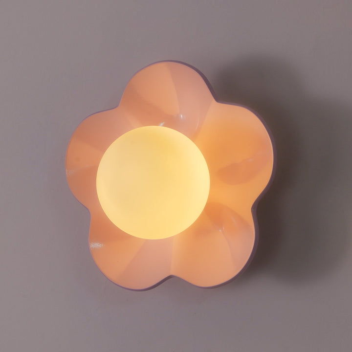 Wall-mounted floral resin lamp, elegant glass shade, modern design.