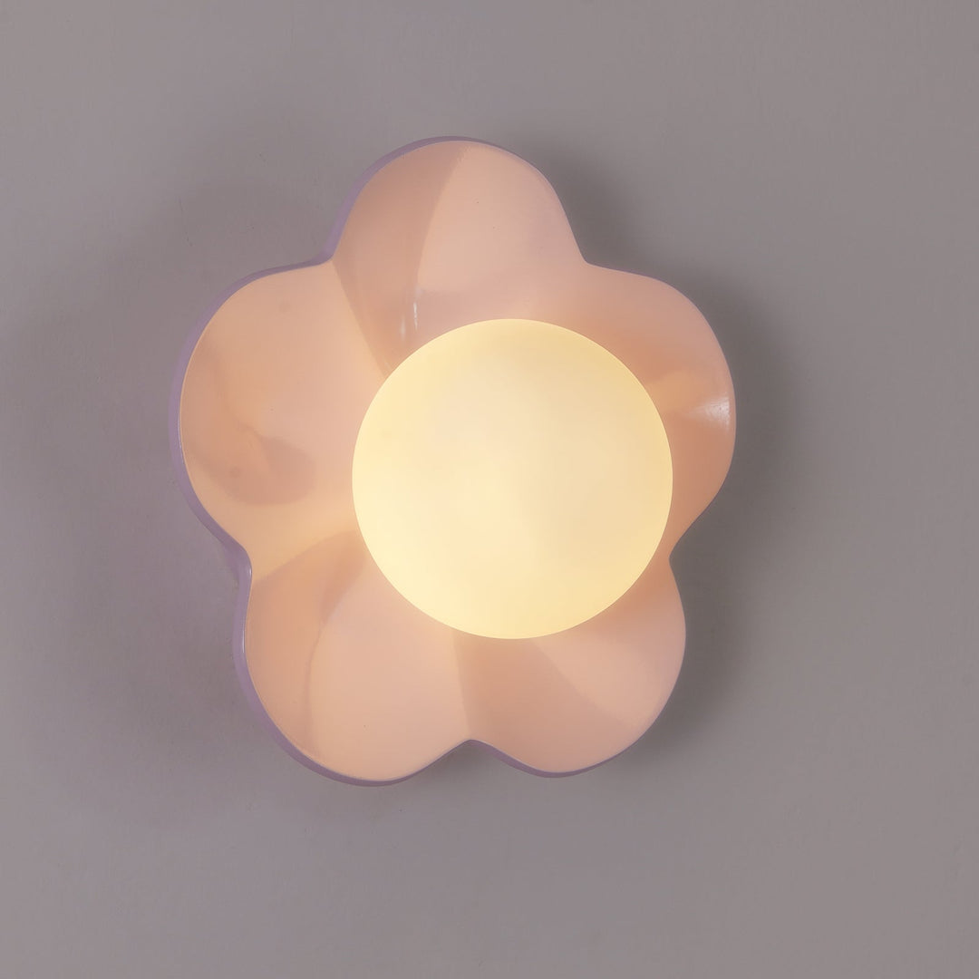 Sculpted floral resin ceiling lamp with a clear glass shade.