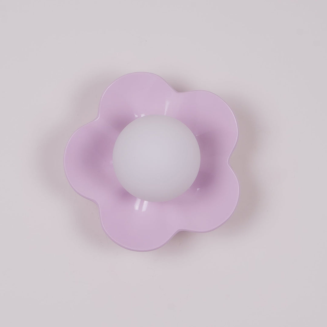 Ceiling-mounted floral resin light, elegant glass shade, modern design.