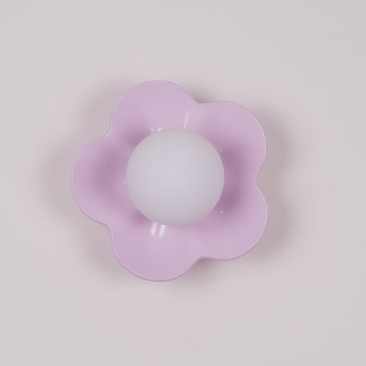 Ceiling-mounted floral resin light, elegant glass shade, modern design.