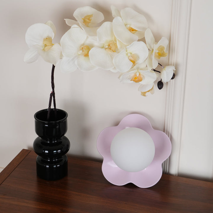 Textured floral resin combined with smooth glass on a modern lamp.