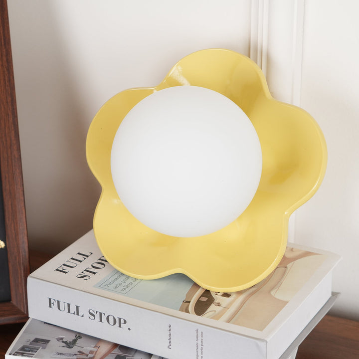 Art-inspired floral resin wall/ceiling light with glass elements.