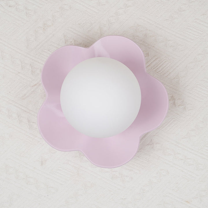 Graceful floral resin wall light with glass shade for modern interiors.