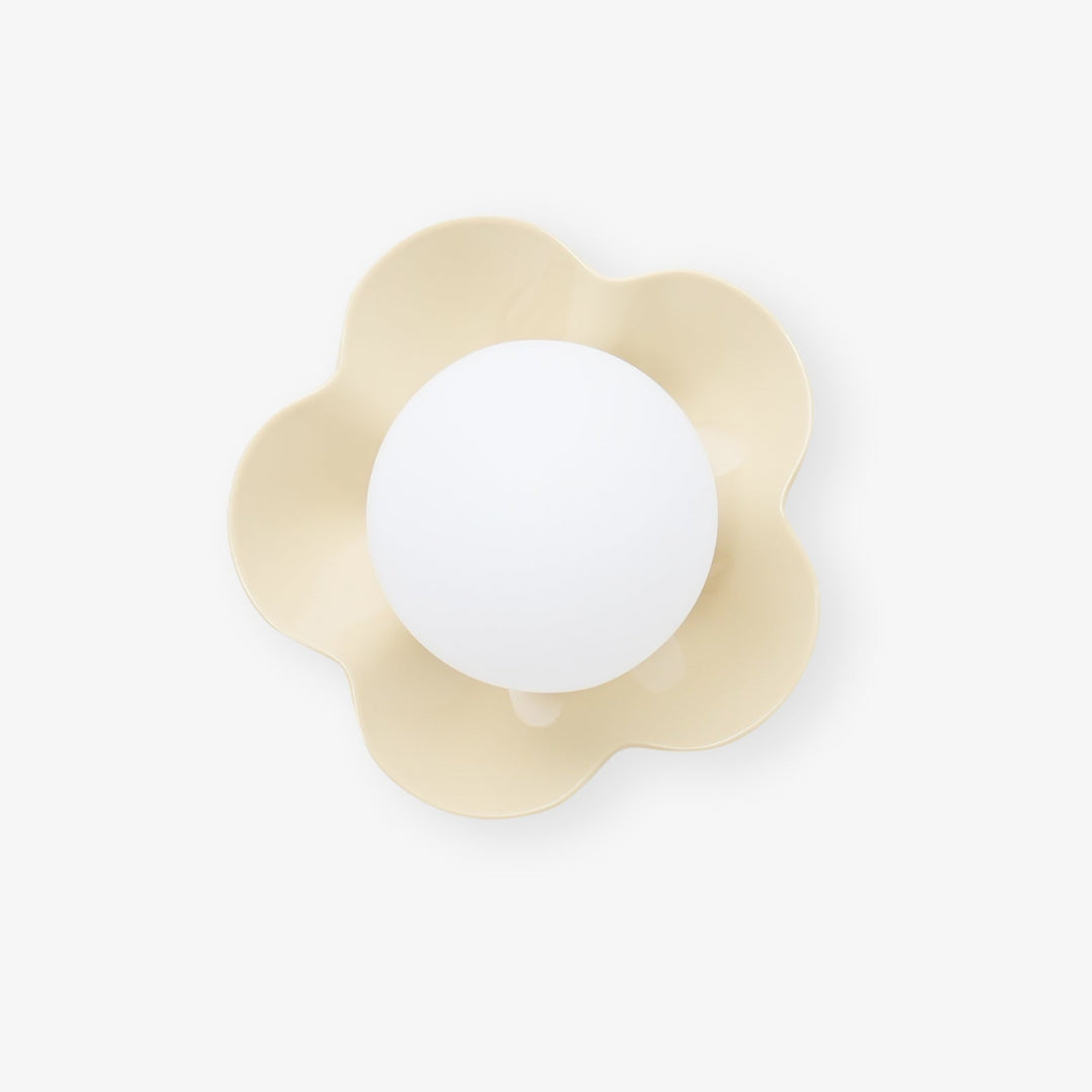 Modern floral resin wall/ceiling light featuring a stylish glass shade.