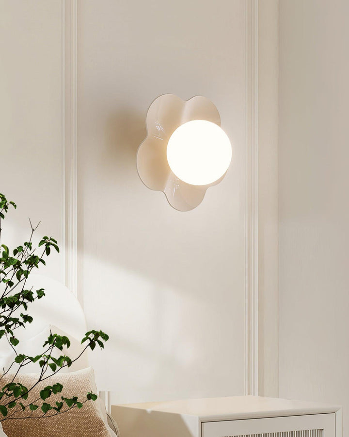 Decorative indoor lamp: Floral resin base & smooth glass shade.