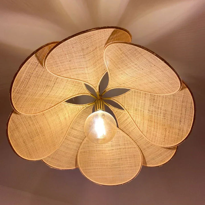 Artistic fabric flower pendant light, casting an ambient glow; a natural centerpiece for any room.