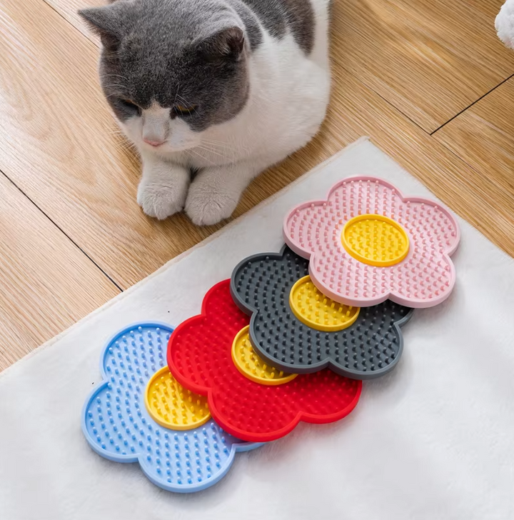 Flower shaped silicone lick mat for cats, a calming slow feeder and floor protector for pet anxiety relief.