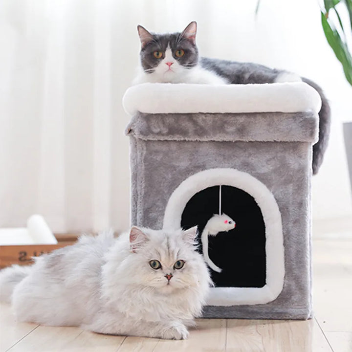Foldable cat cave bed with a soft lying surface and an attached toy. Ideal pet furniture for comfort & play.
