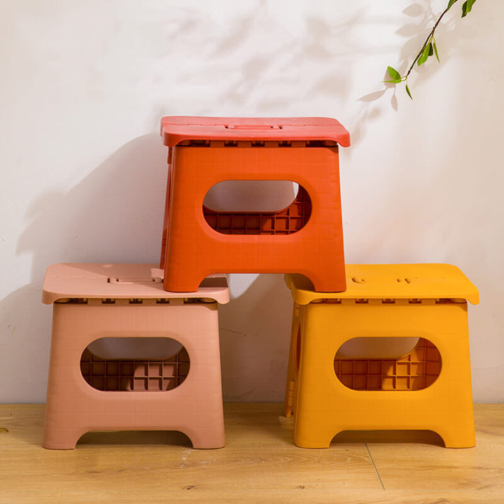 Kids' folding bathroom step stool with handle, ideal for reaching sinks & toilets. Provides a safe height boost.