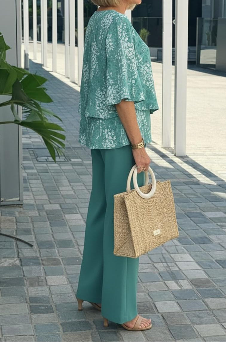 Matching women's co-ord set: fresh teal floral top and wide-leg pants. Stylish two-piece for summer casual wear.