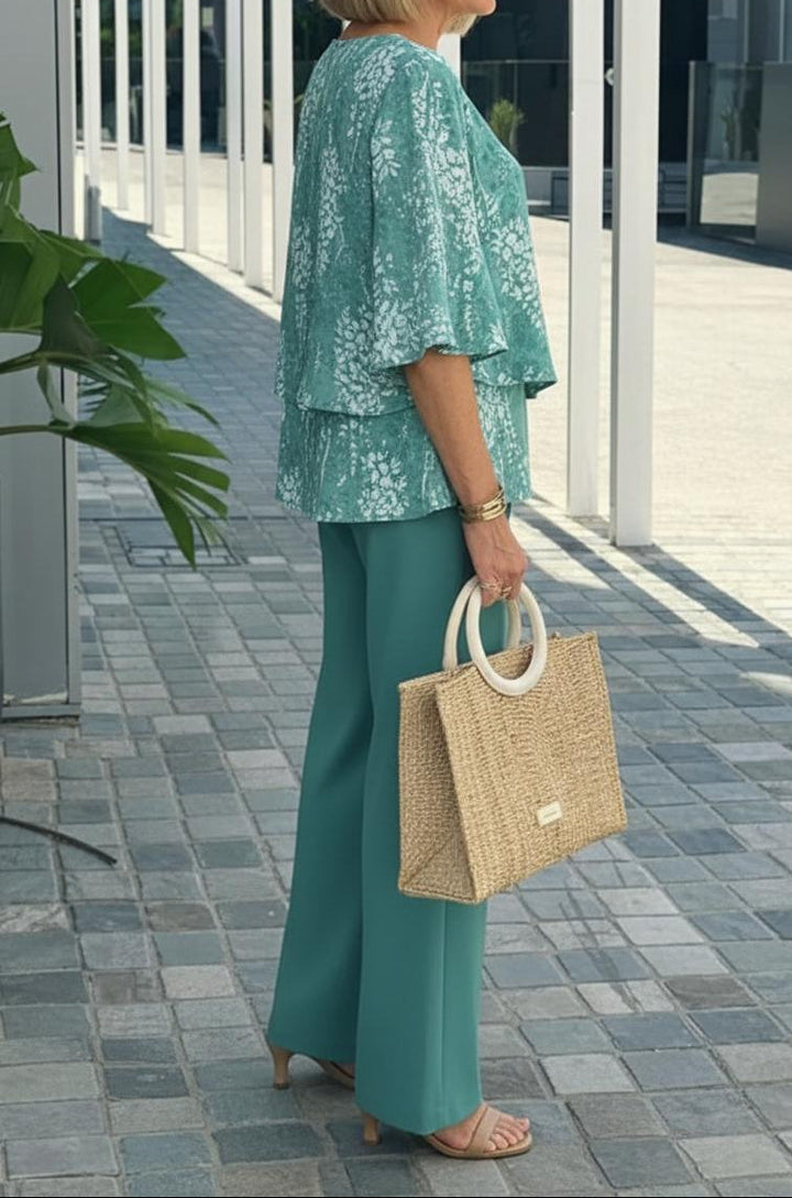 Matching women's co-ord set: fresh teal floral top and wide-leg pants. Stylish two-piece for summer casual wear.