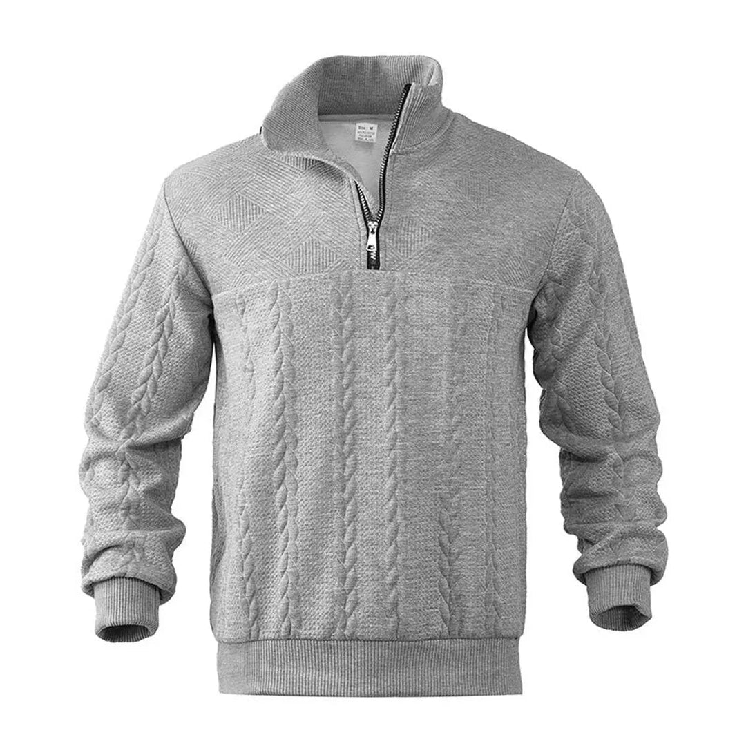 Close-up of intricate cable knit pattern on men's quarter-zip pullover sweater, high quality winter fashion.