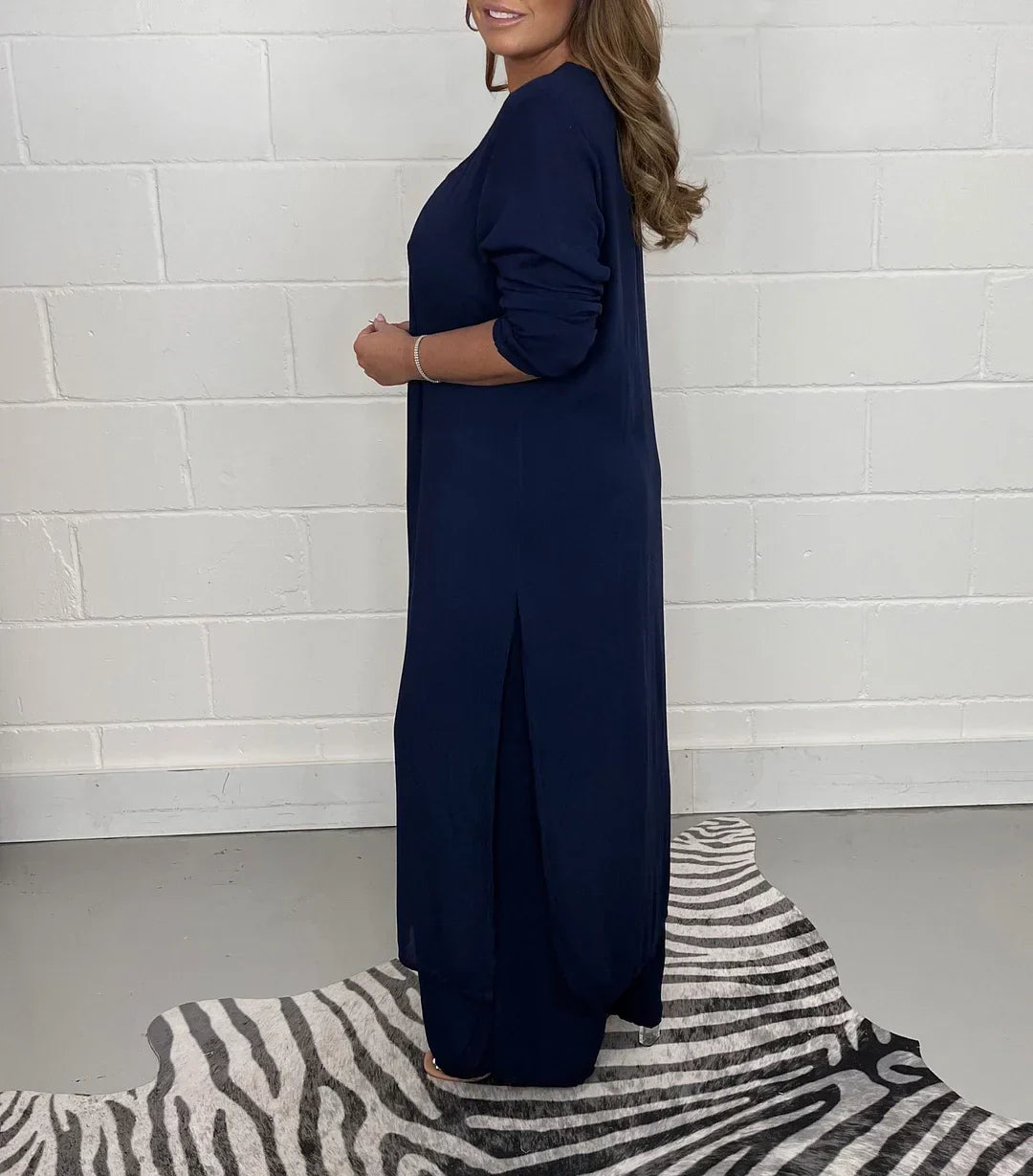 Woman modeling a comfortable relaxed fit long sleeve V-neck casual set, perfect for everyday wear.