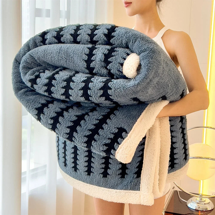 Plush geometric pattern throw blanket with soft Sherpa fleece. Reversible for versatile home decor.