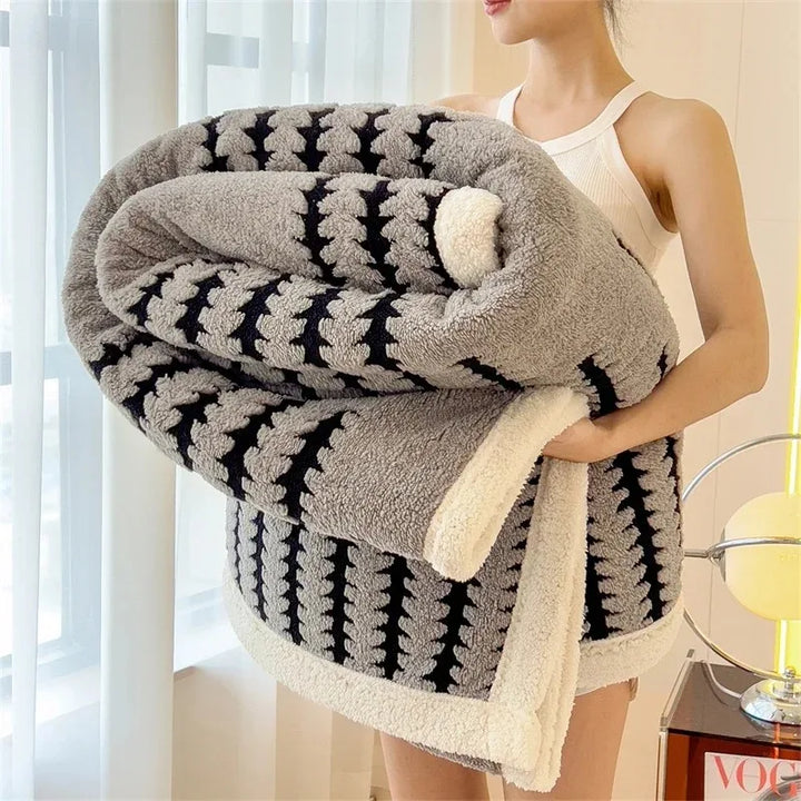 Stylish geometric reversible throw blanket with soft Sherpa fleece, ideal for warm home decor.
