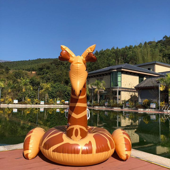People relaxing on a huge inflatable giraffe pool float, bringing summer fun to any pool party or beach.