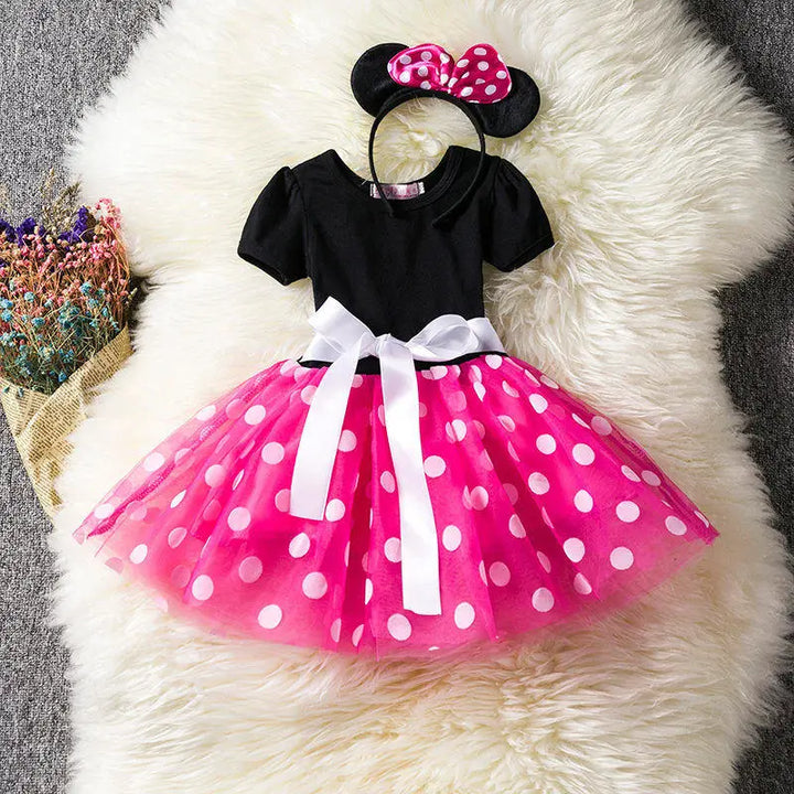 Girls' Minnie Mouse costume: red polkadot dress with black top, bow headband. Perfect for Halloween or dress-up.