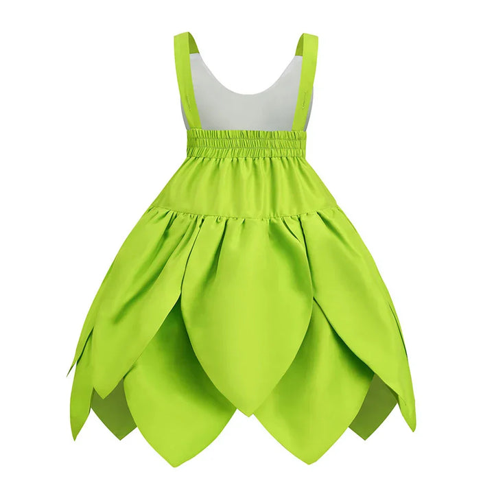 A young girl happily twirling in her magical Tinkerbell fairy party dress.