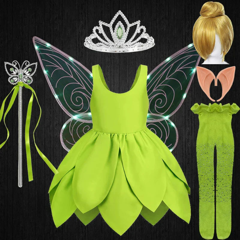 A cute child modeling the complete Tinkerbell costume with wand accessory.