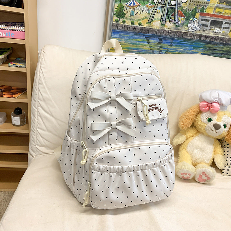 Girls' white polka dot school backpack with a cute bow. Fashionable student bag, perfect for travel & daily use.