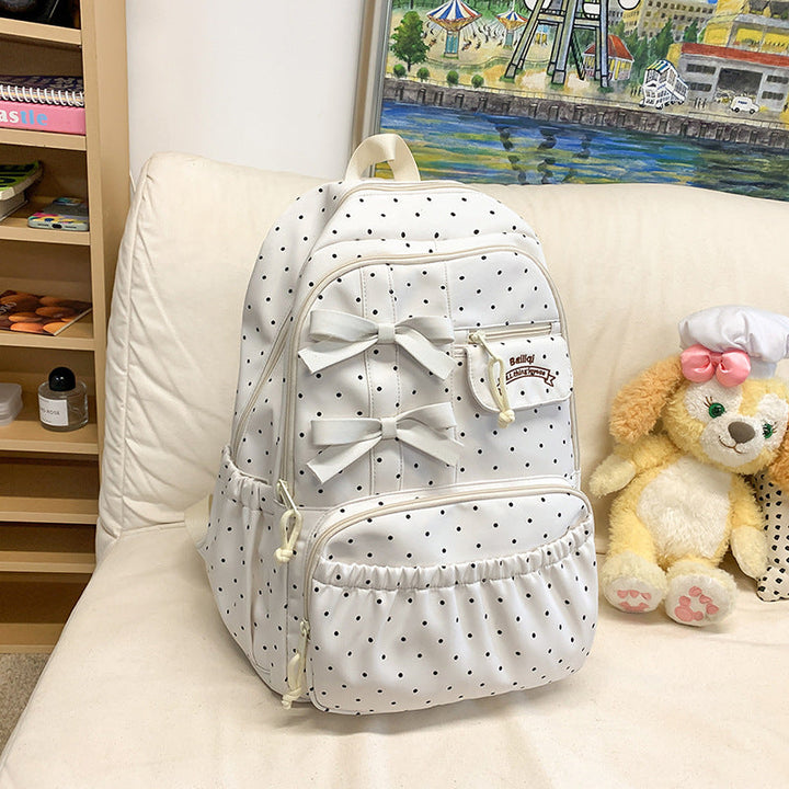 Girls' white polka dot school backpack with a cute bow. Fashionable student bag, perfect for travel & daily use.