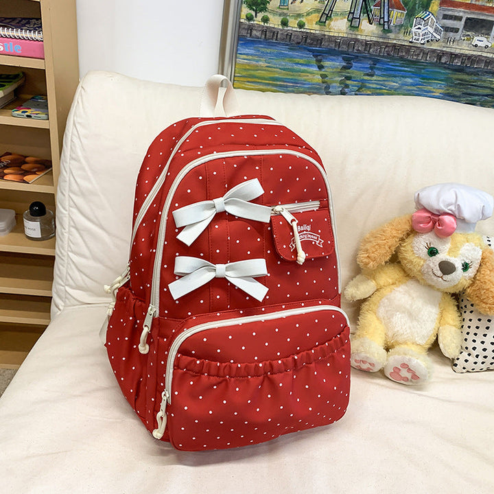 Red polka dot girls' school backpack with a large bow. Stylish student bag, ideal for casual wear & school.