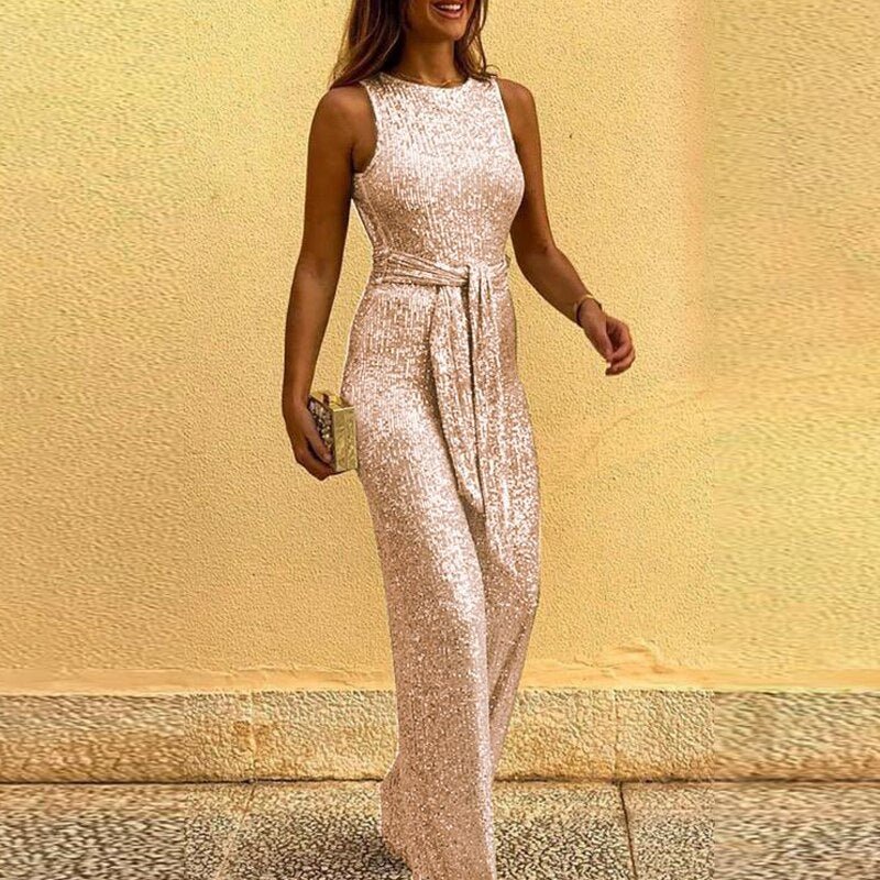 Close-up of sparkling gold sequins on a women's wide-leg jumpsuit, highlighting the elegant waist tie detail.